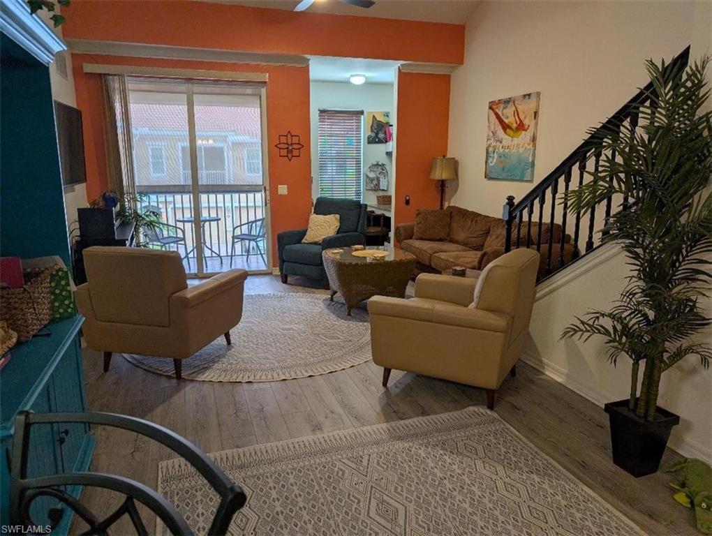 Living room featuring stairs and wood finished floors