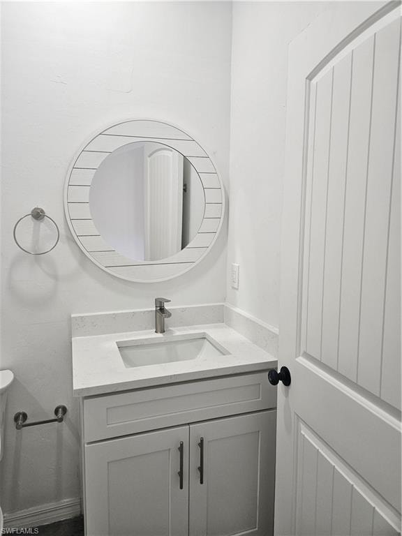 Half bathroom featuring toilet and vanity