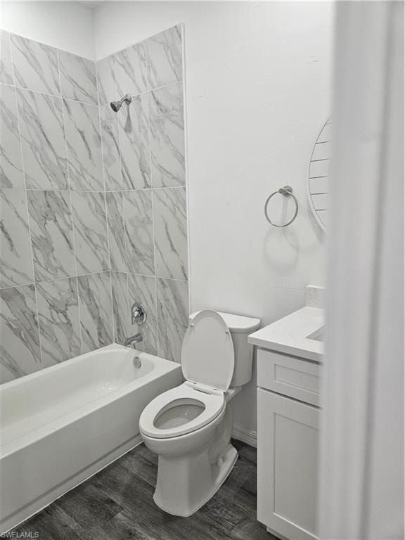 Bathroom with  shower combination, toilet, vanity, and wood finished floors