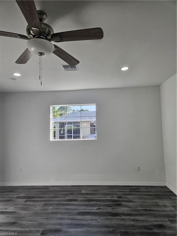 Empty room featuring recessed lighting, dark wood-style flooring, baseboards, visible vents, and a ceiling fan