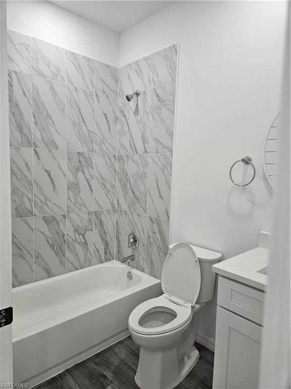 Bathroom featuring tub / shower combination, toilet, vanity, and wood finished floors