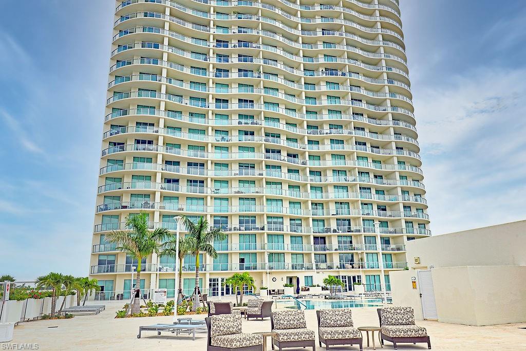 High-rise building with a curved façade and multiple private balconies
