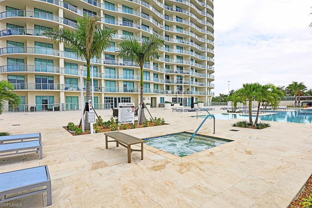 Expansive outdoor amenity deck featuring a bubbling spa and multiple pools