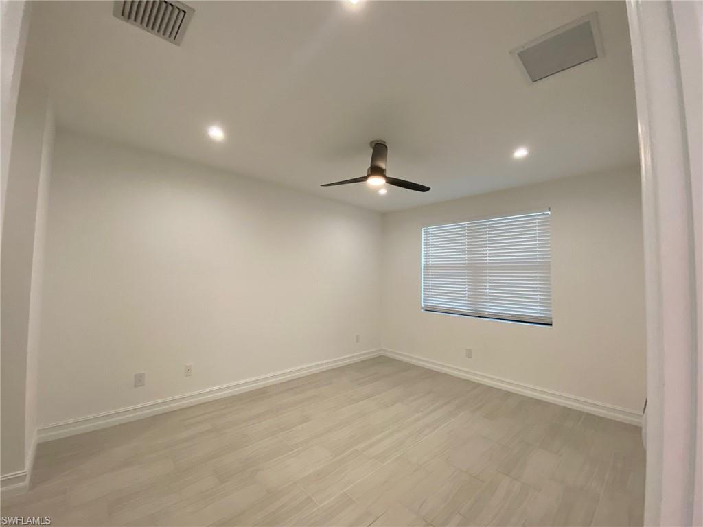 Room featuring light-toned tile flooring, recessed ceiling lighting, a modern ceiling fan, and a window with horizontal blinds