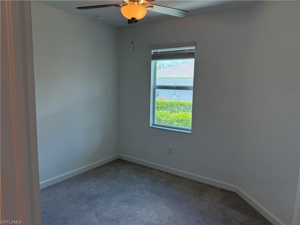 Carpeted room 2 with a single window, a ceiling fan with integrated lighting, and white baseboards