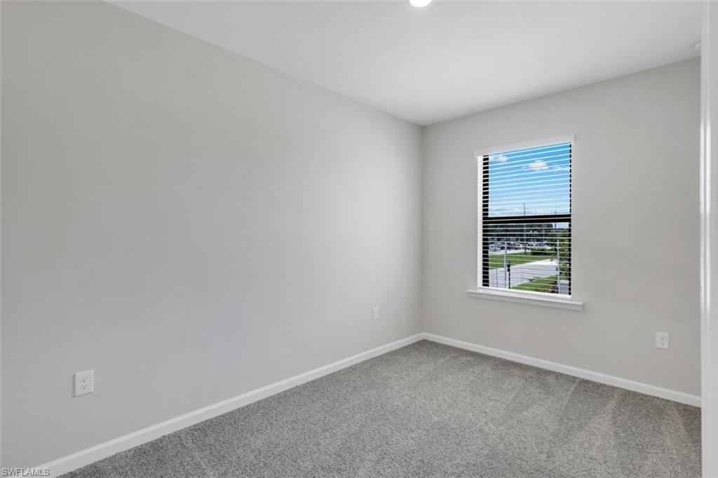 Bedroom 3 with light gray interior paint and gray carpeting create a neutral palette