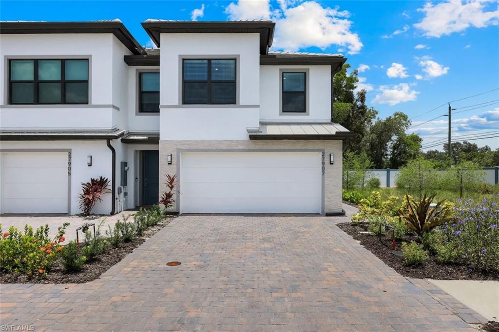 Contemporary stucco exterior with a stone veneer accent
