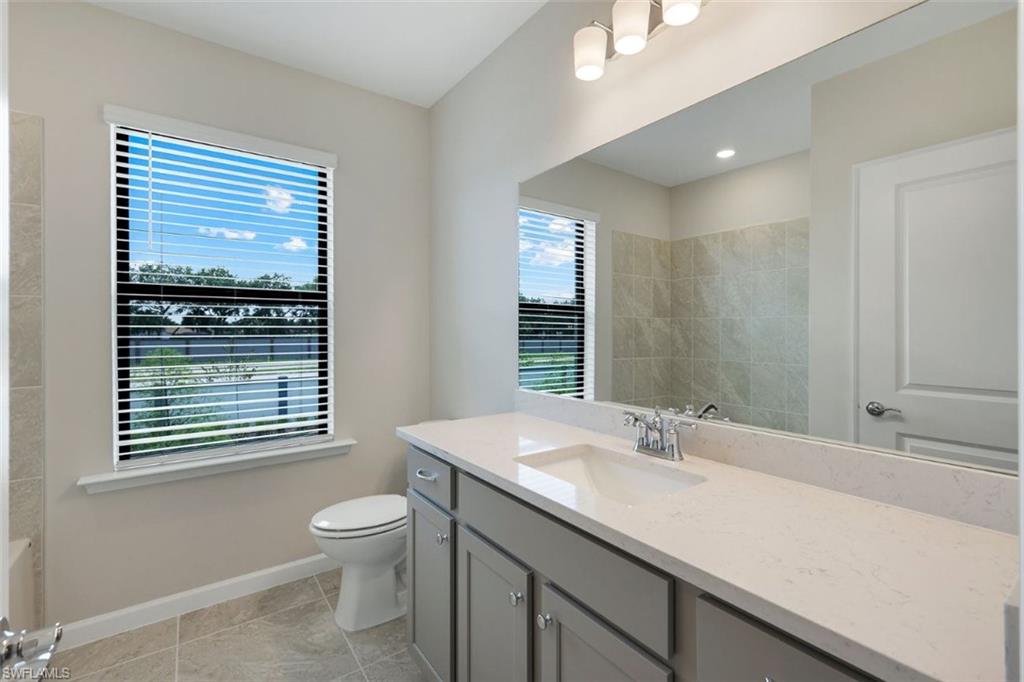 Bathroom 2 with vanity featuring an integrated sink, light-toned countertop, and gray cabinetry with brushed nickel hardware