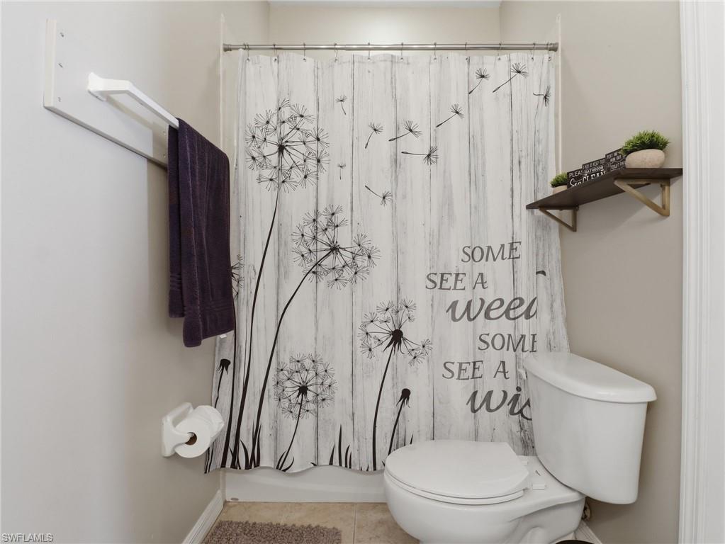 White toilet with a built-in shelf and towel bar