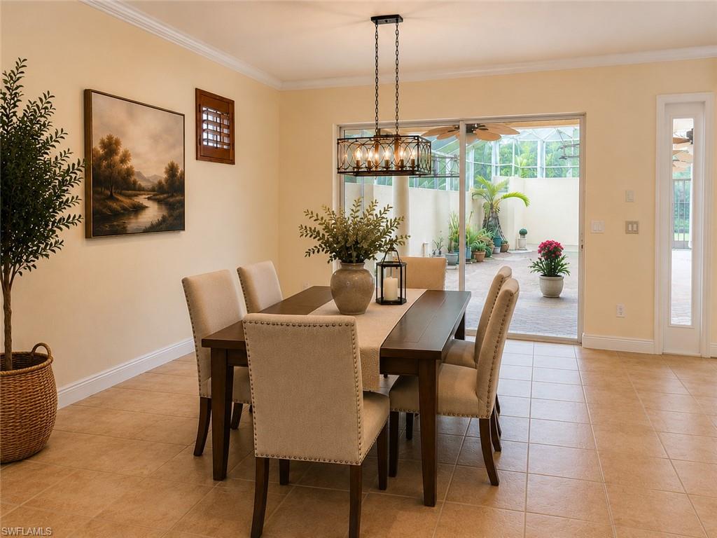 Dining area featuring neutral wall tones, crown molding, and a rectangular chandelier