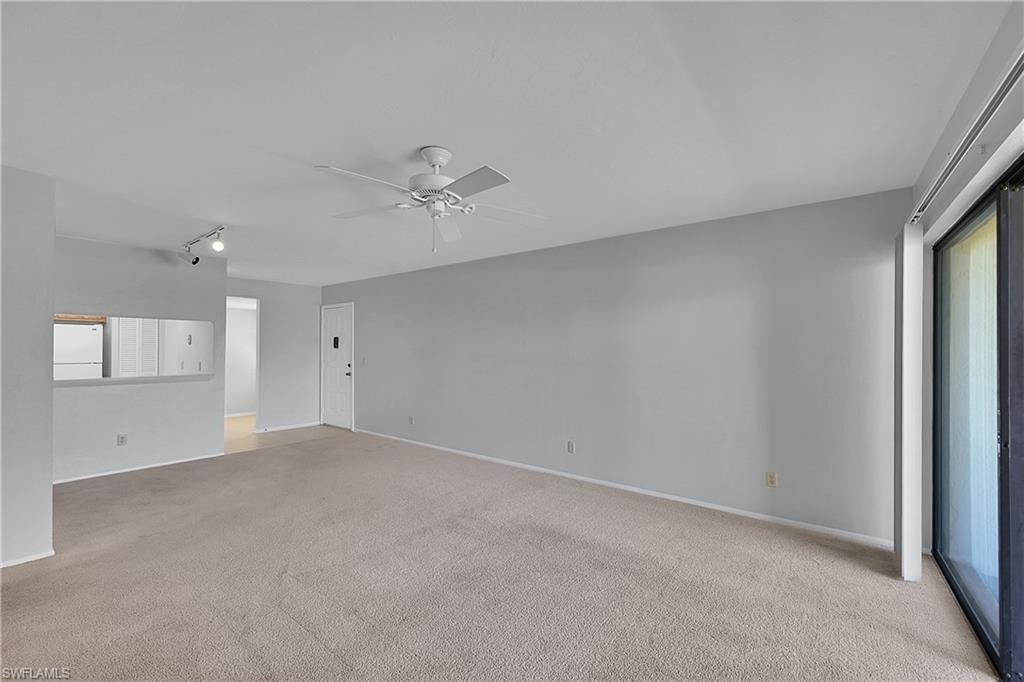 Spare room with light colored carpet and ceiling fan