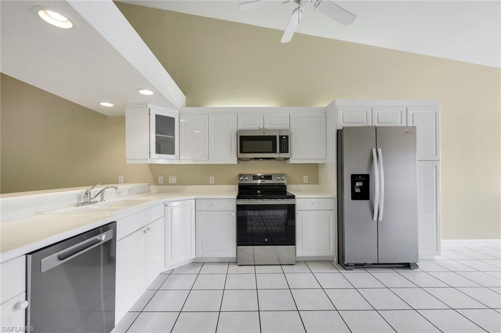 WHITE CORIAN COUNTERS AND TILE FLOORING