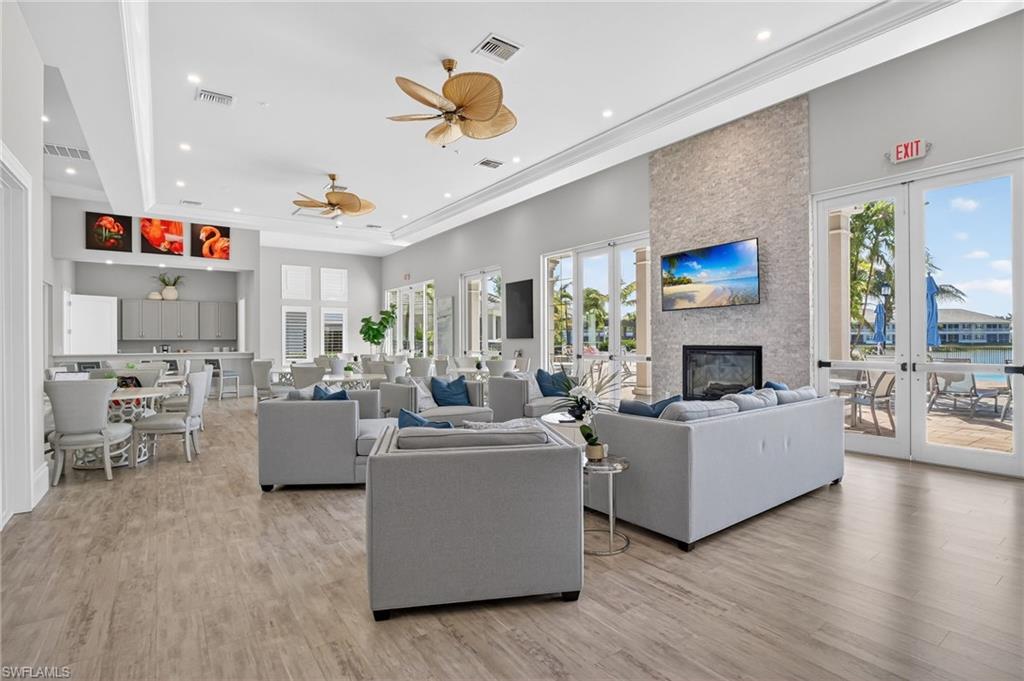Spacious common area featuring wood-finish flooring, recessed lighting, and crown molding