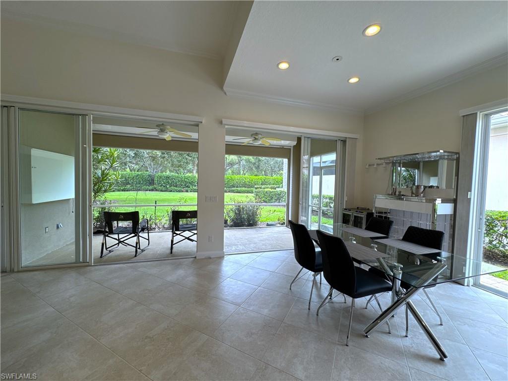 The open-concept dining area flows seamlessly with the living room and kitchen, creating an inviting space for entertaining. Enjoy views of the beautifully landscaped backyard through the sliding glass doors, with a built-in wine and beverage cooler featuring storage for up to 42 bottles and convenient stemware storage.