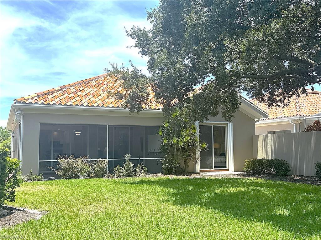 Beautifully landscaped backyard offering a private and serene outdoor setting with lush tropical surroundings and plenty of space to enjoy the Naples lifestyle.