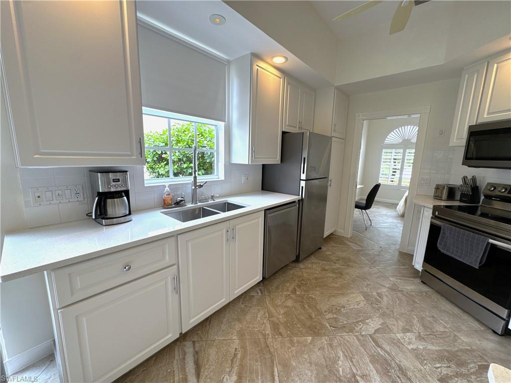 Kitchen which also has an entryway to the den.