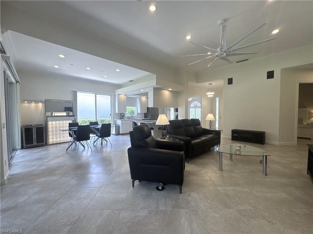 The spacious living room is furnished with comfortable power reclining seating, creating the perfect place to unwind after a day at the beach or enjoying the community amenities.