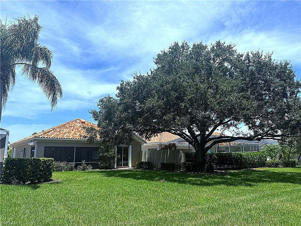 Beautifully landscaped backyard offering a private and serene outdoor setting with lush tropical surroundings and plenty of space to enjoy the Naples lifestyle.