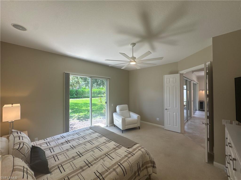 The spacious primary suite features a brand-new king-size bed with a never-used mattress, along with a comfortable power reclining chair—creating the perfect retreat after a day enjoying the Naples lifestyle or Village Walk's resort-style amenities.