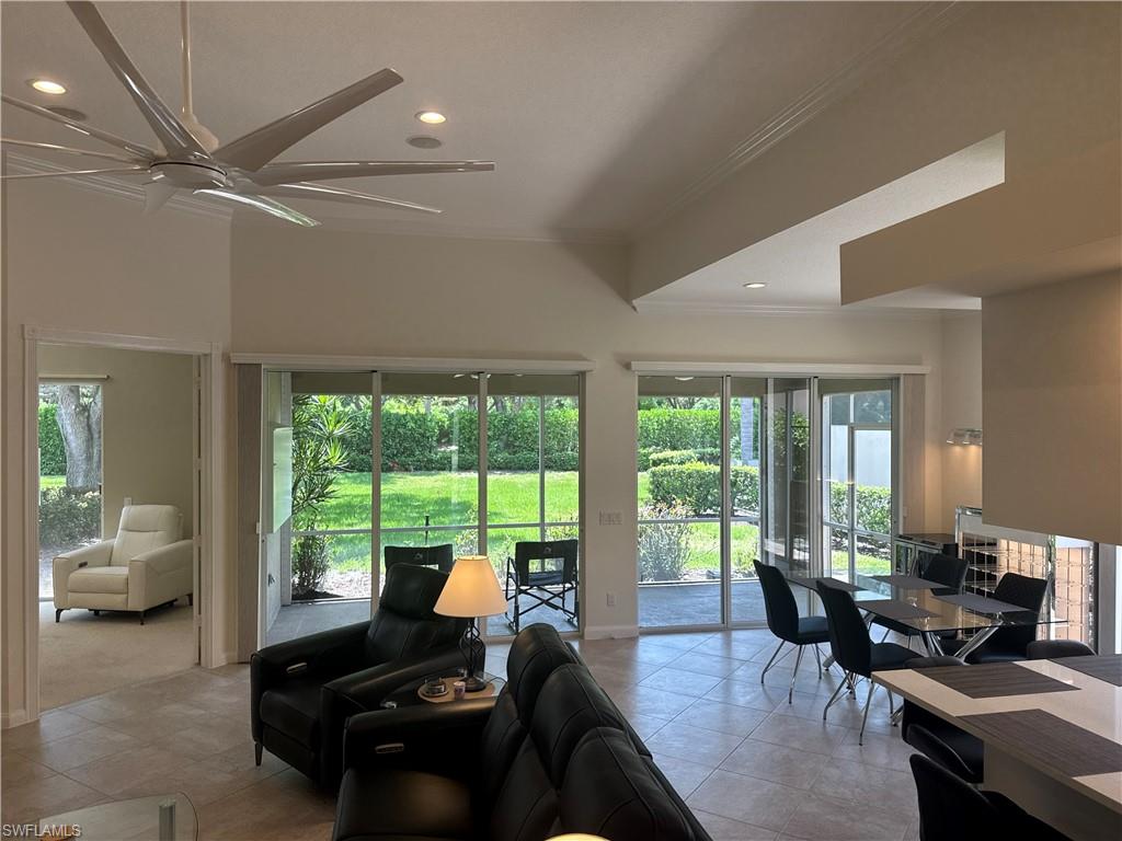 The spacious living room is furnished with comfortable power reclining seating, creating the perfect place to unwind after a day at the beach or enjoying the community amenities.