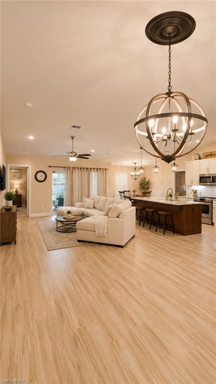 Spacious open-concept interior featuring light wood-finish flooring