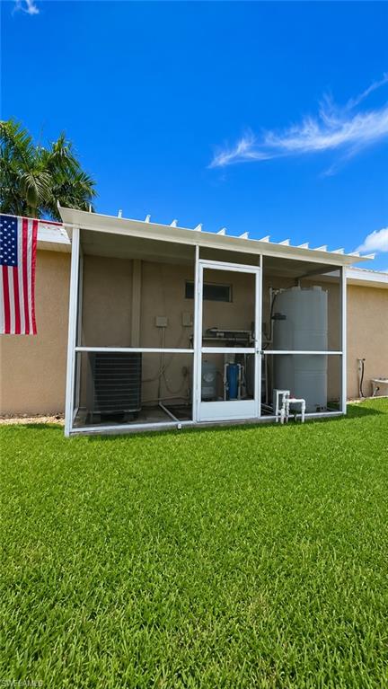 Screened enclosure featuring a water softener system and additional utility equipment