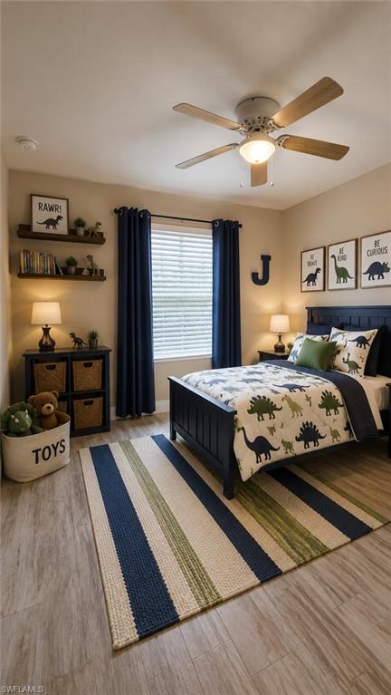 Bedroom featuring wood-finish flooring, a ceiling fan with integrated lighting, a window with blinds and dark drapery, and a built-in wall shelf system