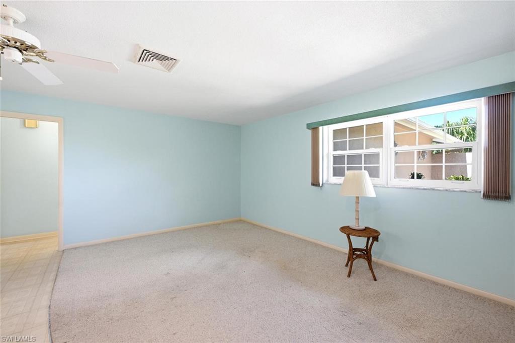 Carpeted interior space with light blue walls and a white ceiling