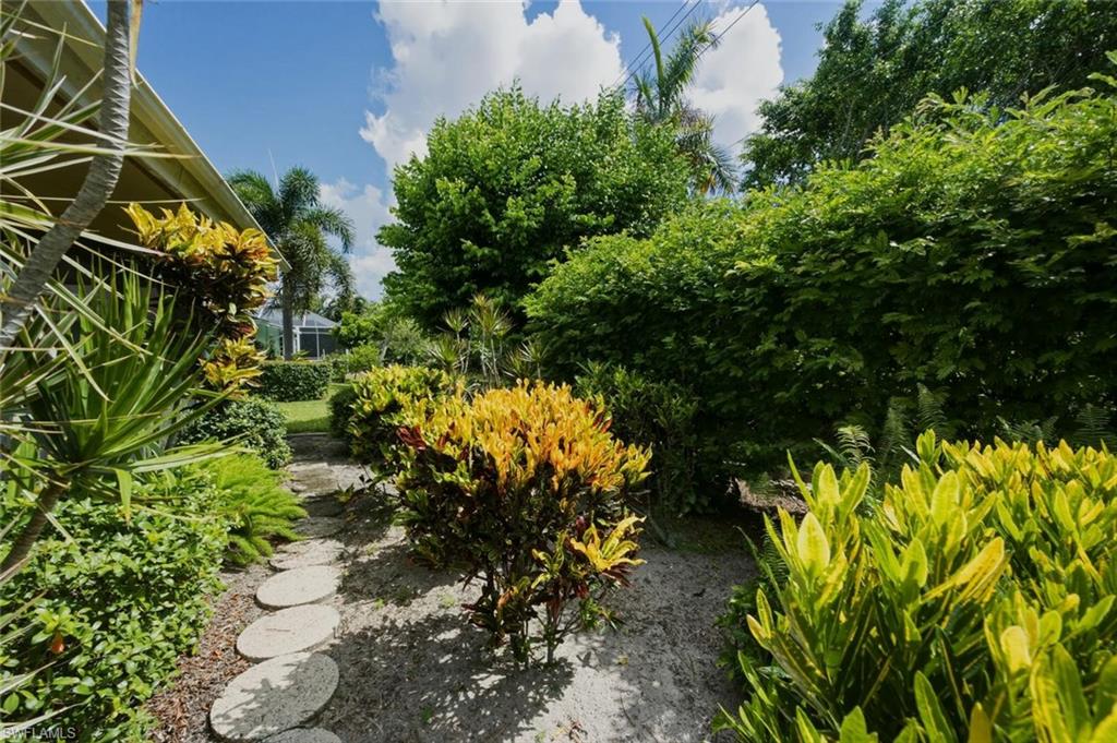 Manicured landscaping featuring a stone paver pathway