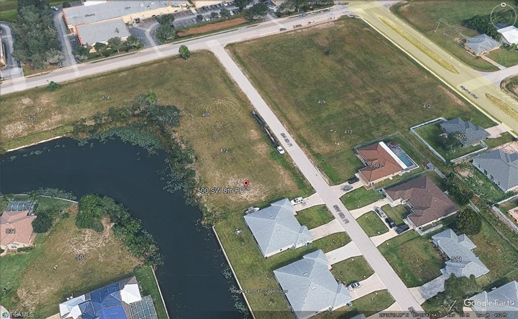 Vacant land parcel featuring canal frontage, street access, and a level buildable area