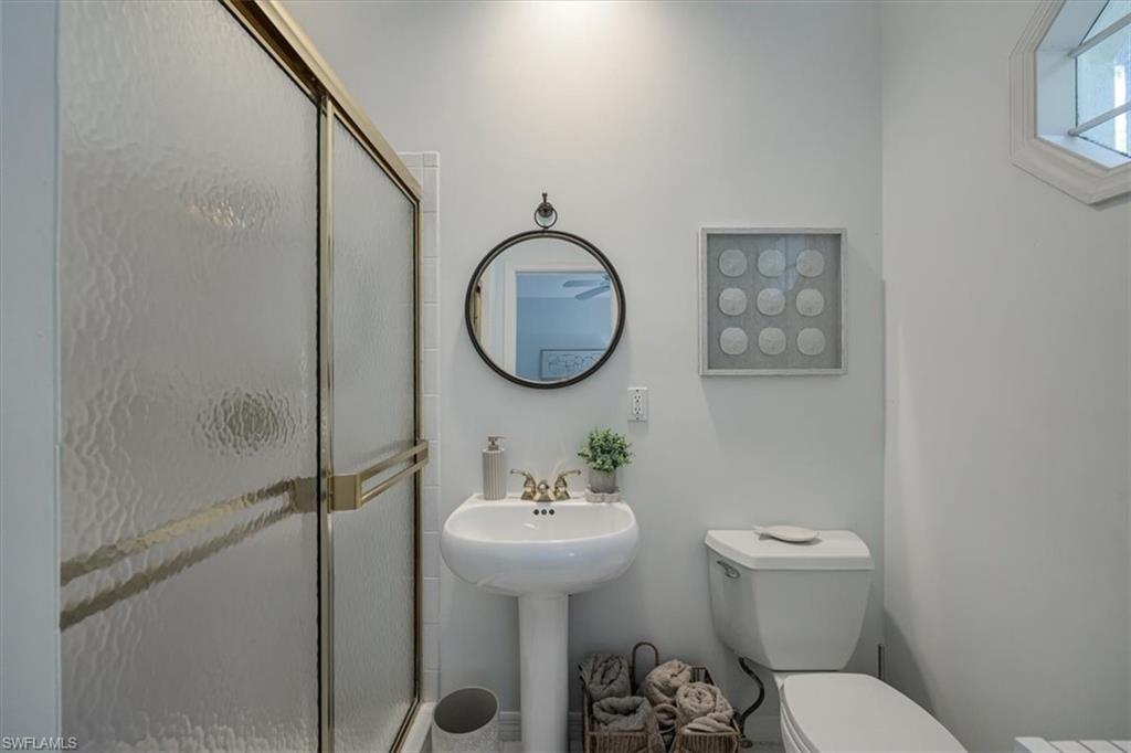 Bathroom with toilet and a stall shower