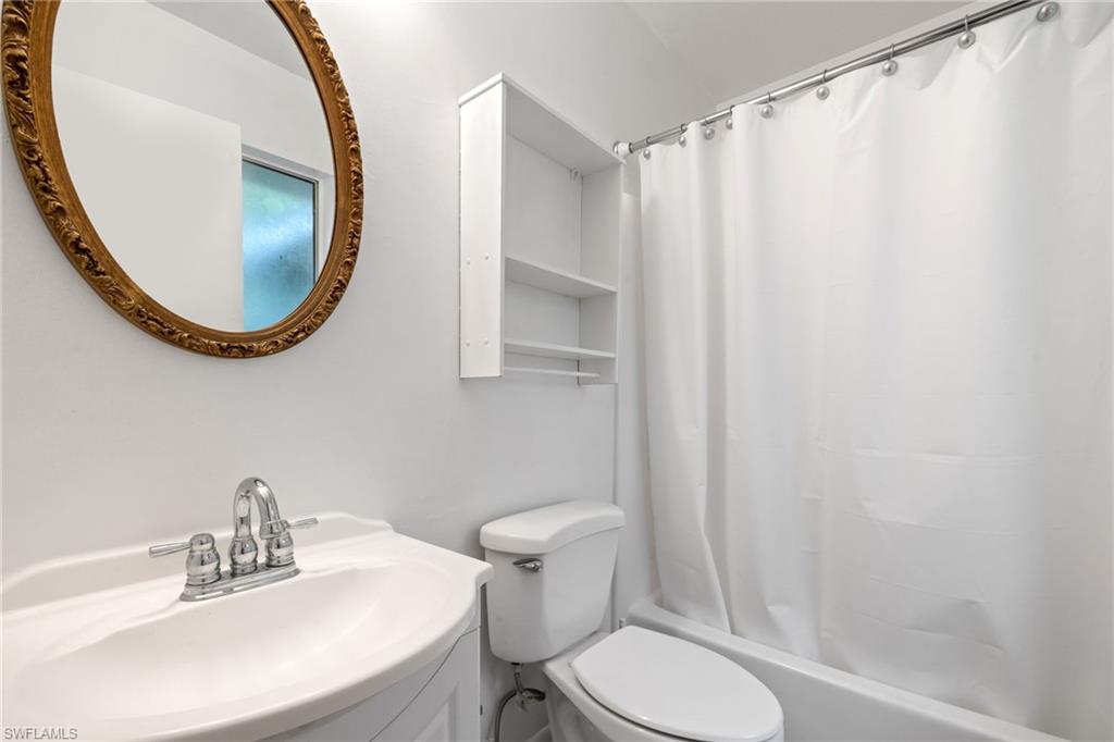 White vanity with an integrated sink and chrome faucet