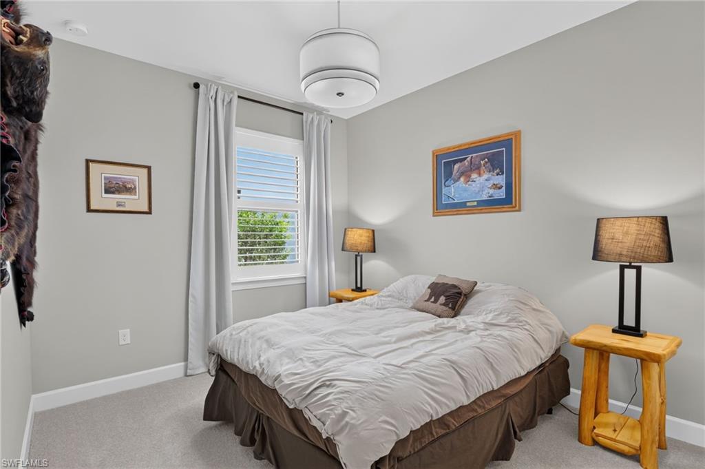 Bedroom featuring neutral wall paint, white trim, and light gray carpeting