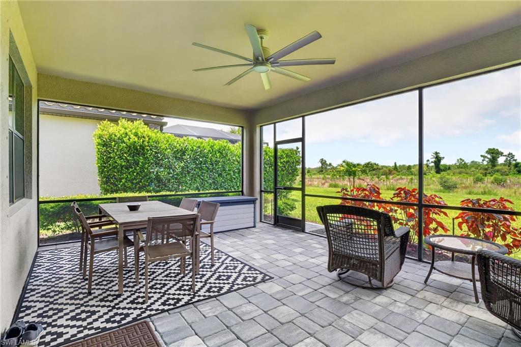 Screened lanai featuring a paver patio and ceiling fan