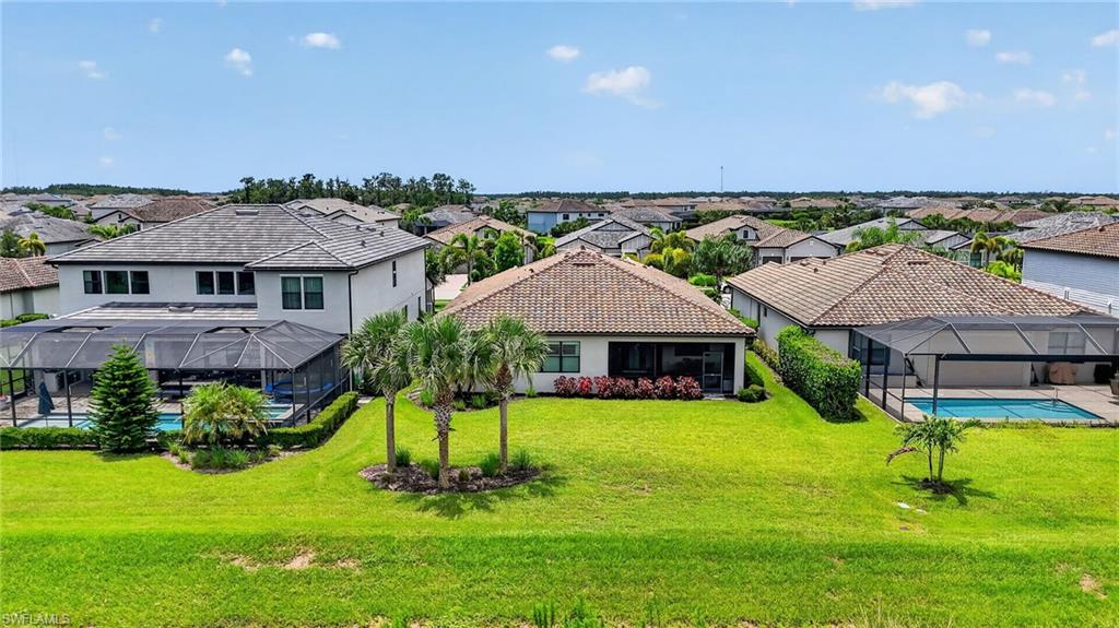 Expansive green space featuring a tropical landscape with mature palm trees and lush lawn