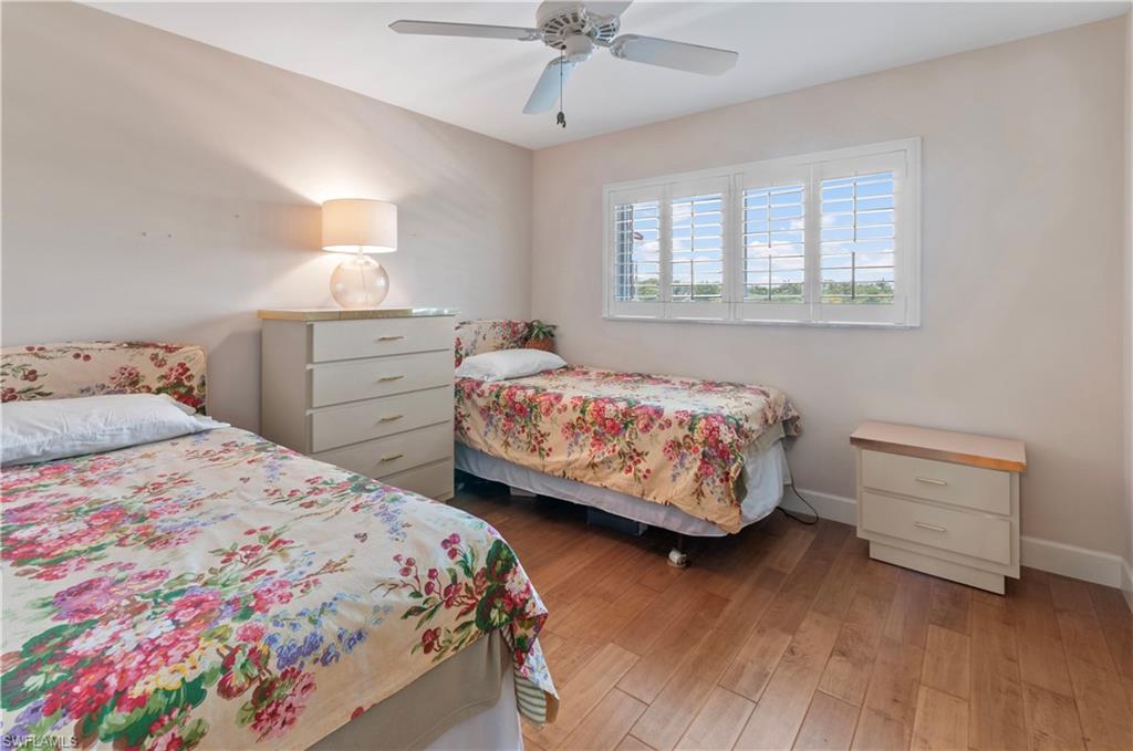 Guest bedroom, wood floors, plantation shutters.