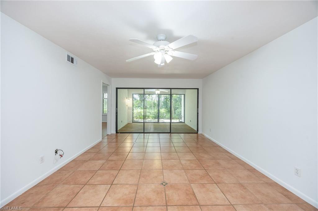 Living room with view into all season room.