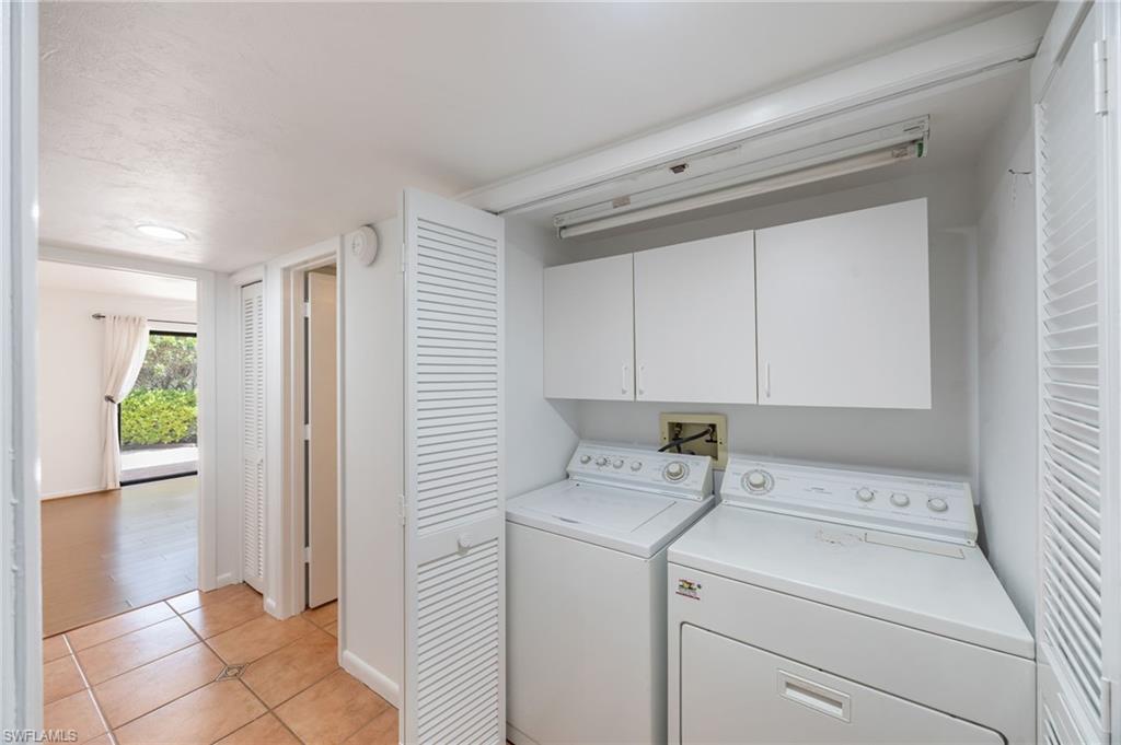 Laundry area includes extra storage cabinets