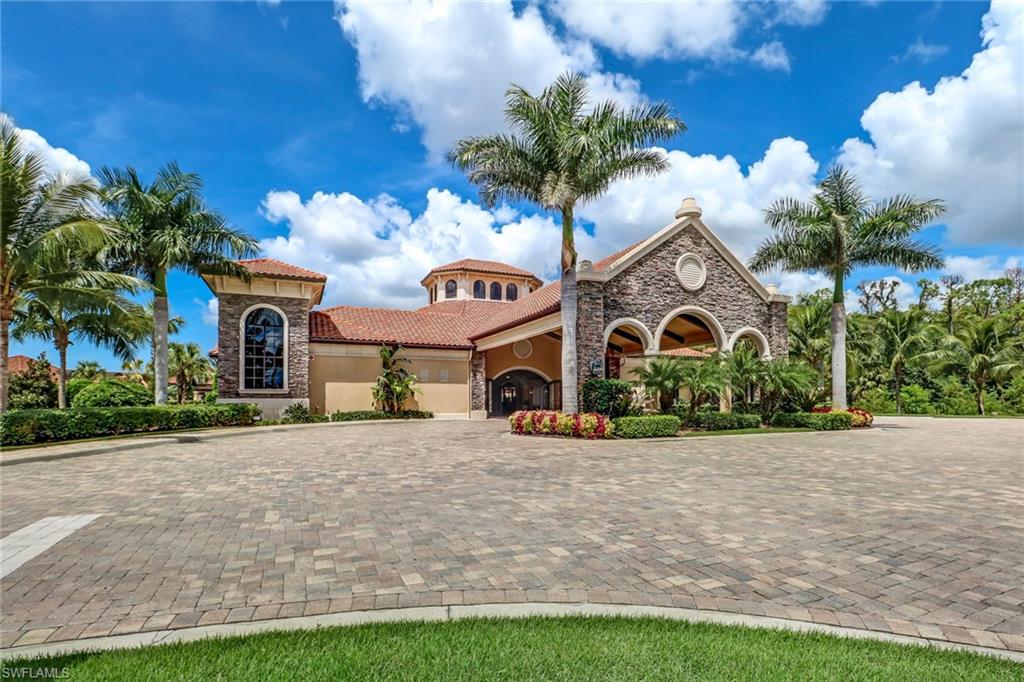 Mediterranean / spanish home featuring stone siding, stucco siding, curved driveway, and a tiled roof