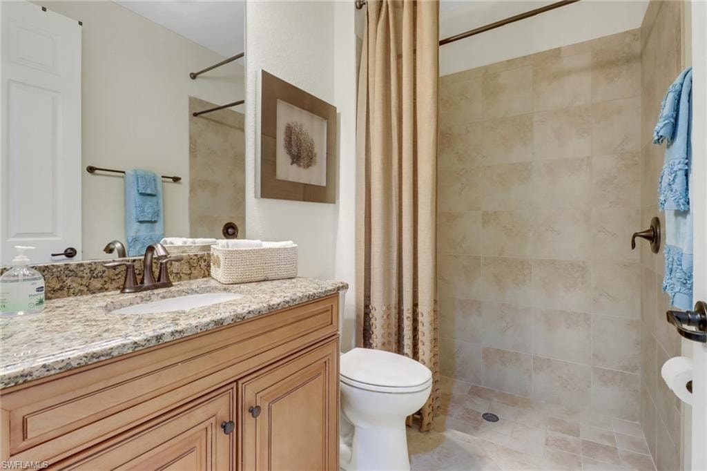 Full bath with vanity and a tile shower