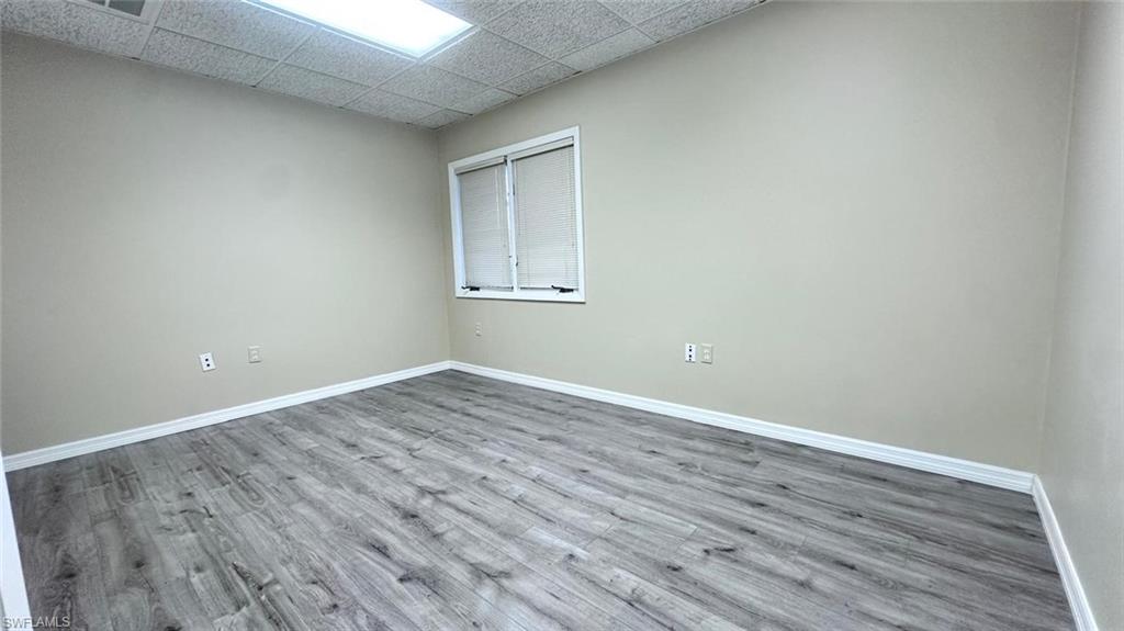 Neutral painted walls with white trim and wood-finish flooring