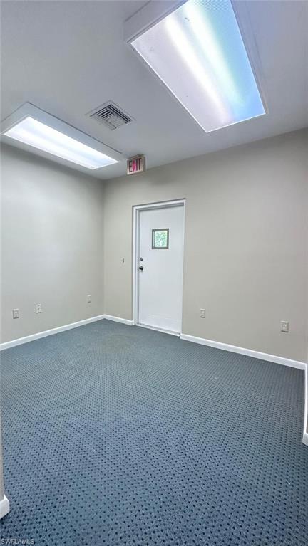 Neutral wall paint with blue patterned carpet