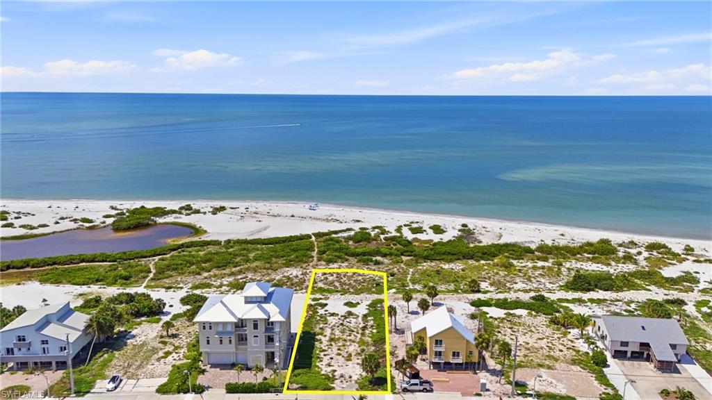Beachfront land parcel featuring direct access to the sandy shoreline and expansive water - Virtually Edited Image