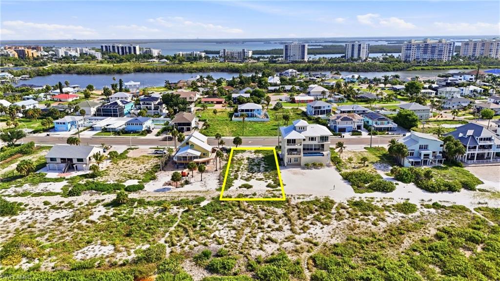Coastal property featuring a cleared lot with surrounding beach vegetation - Virtually Edited Image