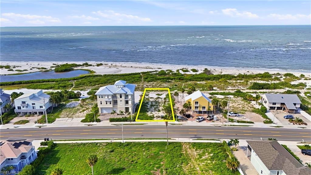 Beachfront lot featuring direct ocean access, sandy terrain, and proximity to paved road infrastructure - Virtually Edited Image