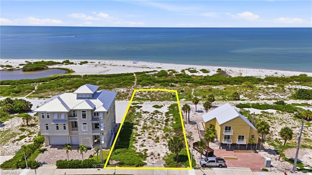 Expansive lot featuring direct beach proximity, clear ocean frontage, and natural coastal vegetation - Virtually Edited Image