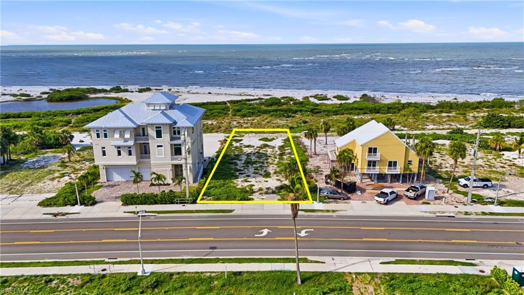 Level lot featuring partial vegetation, street frontage, and beachfront proximity - Virtually Edited Image