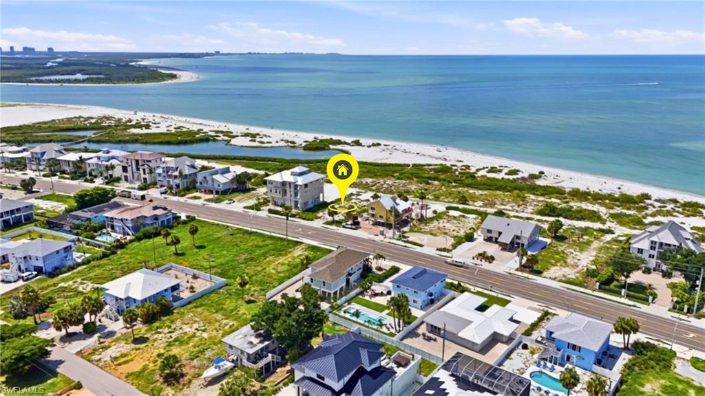 Aerial perspective showcasing a coastal property with direct proximity to the Gulf of Mexico - Virtually Edited Image