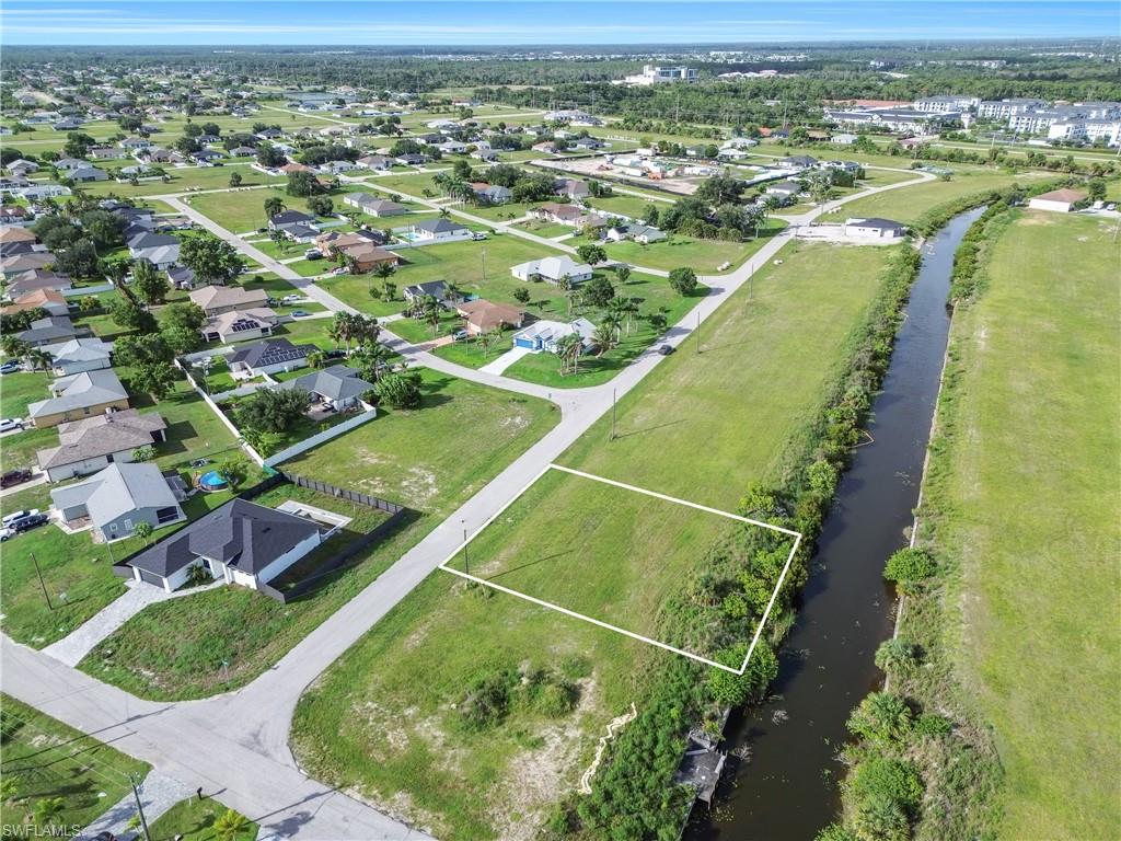 Expansive canal-front lot featuring lush green space