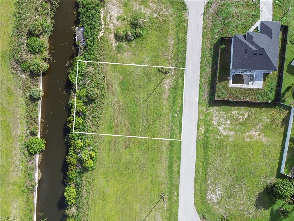 Cleared lot featuring an adjacent canal and paved road access